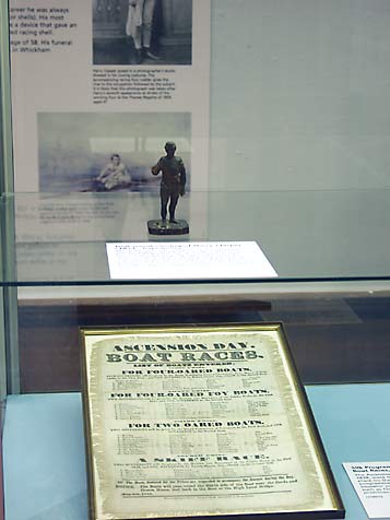 Wooden figure and boat race flyer